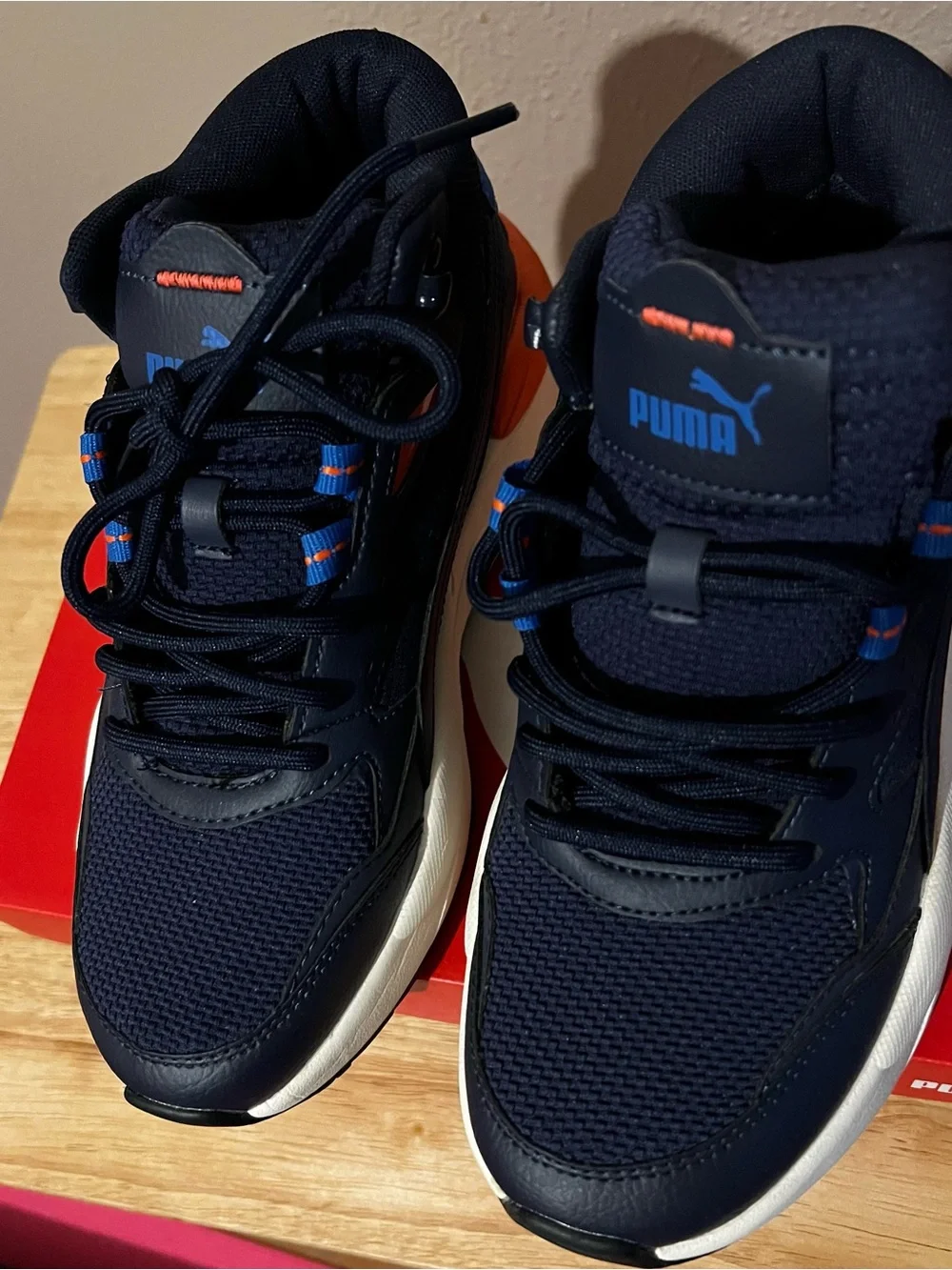 Puma Navy Blue High-Top Athletic Sneakers with Orange Accents